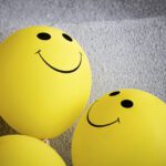 Incentives - yellow smiley emoji on gray textile